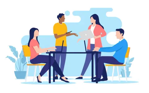 Équipe discutant autour d'une table, ordinateurs portables, plantes. Une scène de travail moderne, reflet de l'actualité droit social.