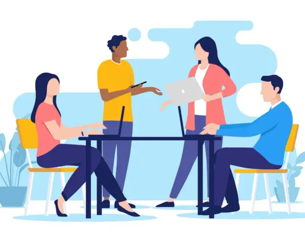 Équipe discutant autour d'une table, ordinateurs portables, plantes. Une scène de travail moderne, reflet de l'actualité droit social.