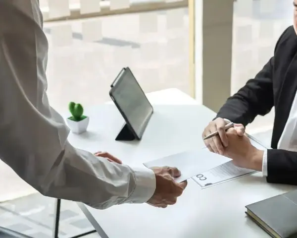Un employé remet une lettre à son supérieur. Une étape importante pour savoir comment démissionner d'un CSE.